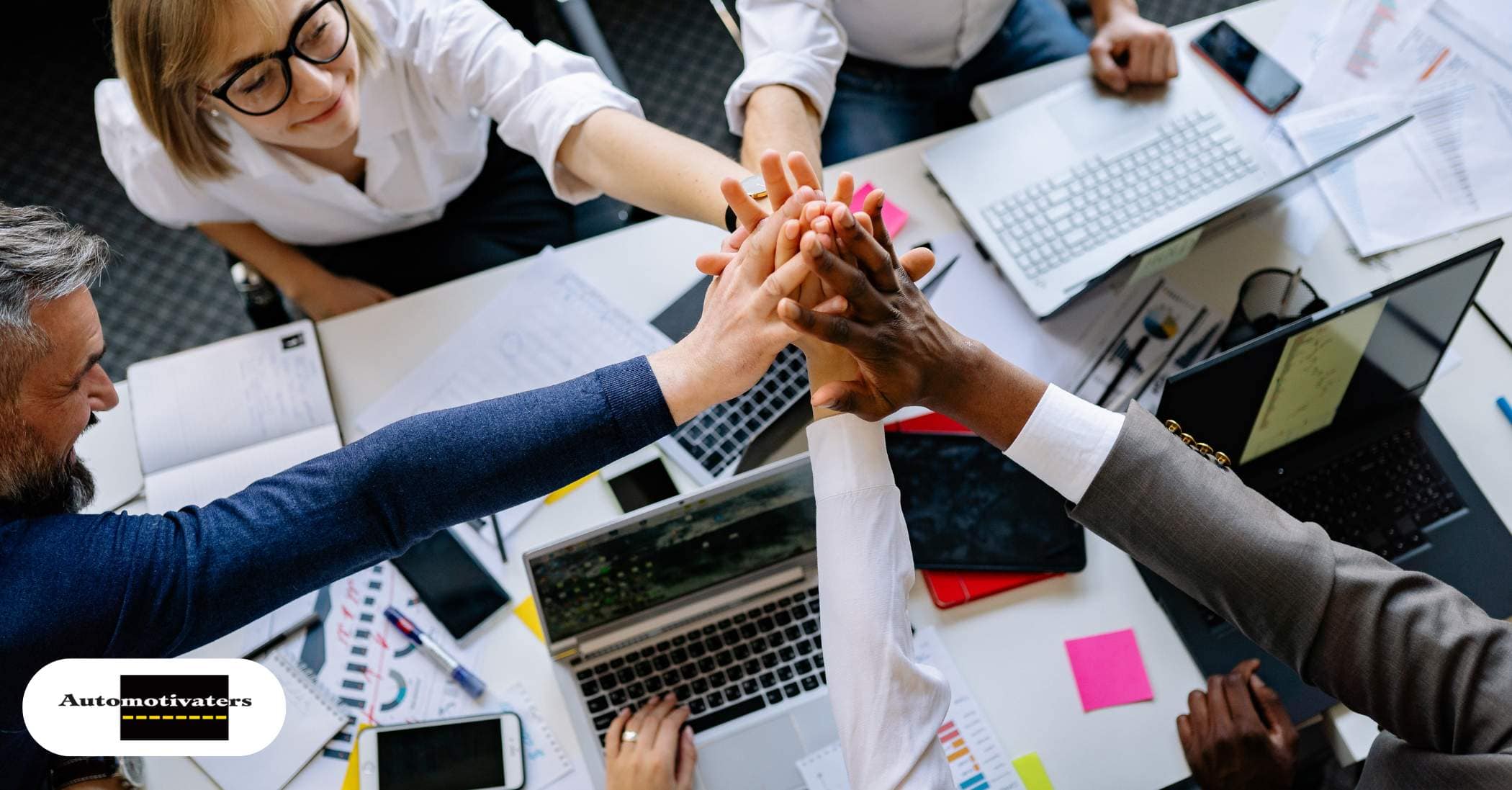 A diverse sales team collaborating around a table with a confident leader guiding the discussion