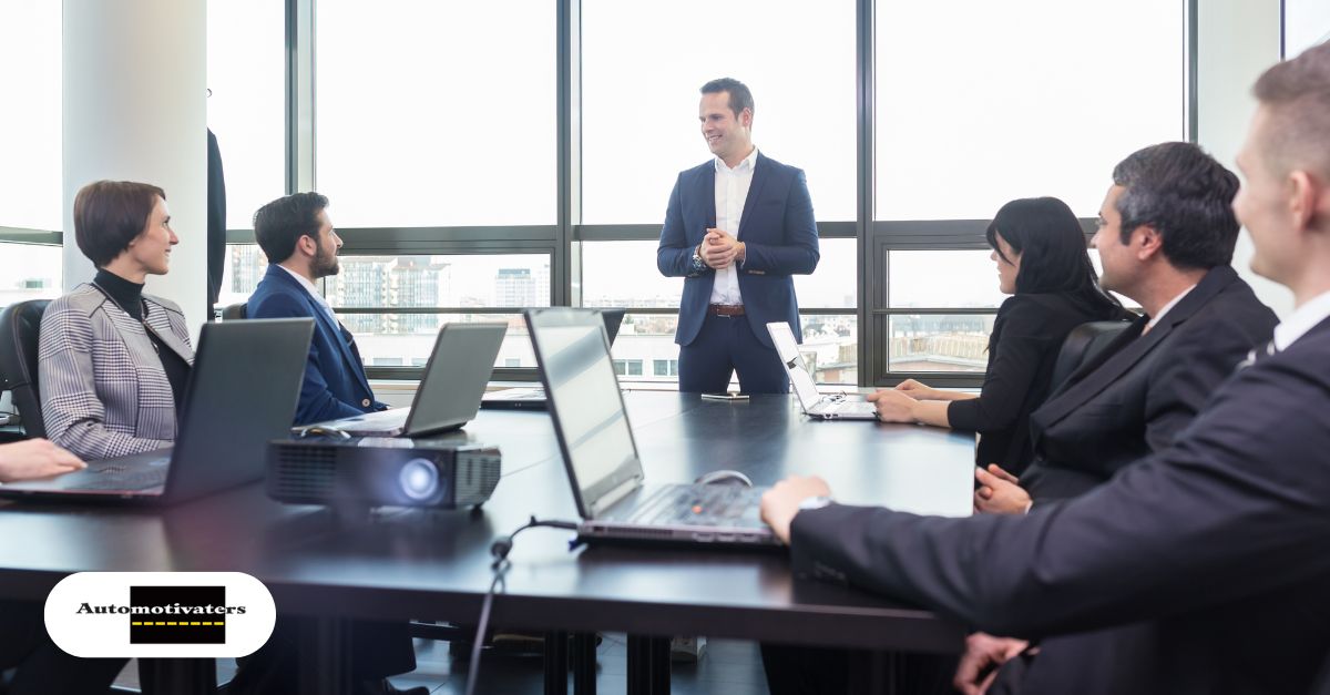 Dealership manager coaching an employee in a supportive one-on-one conversation